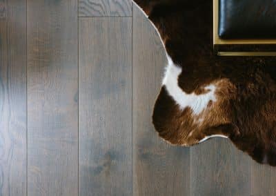 Vienna Woods Timber Flooring Dark Brown Oiled Wood Floor Distilled Pina. Close up with animal skin rug.