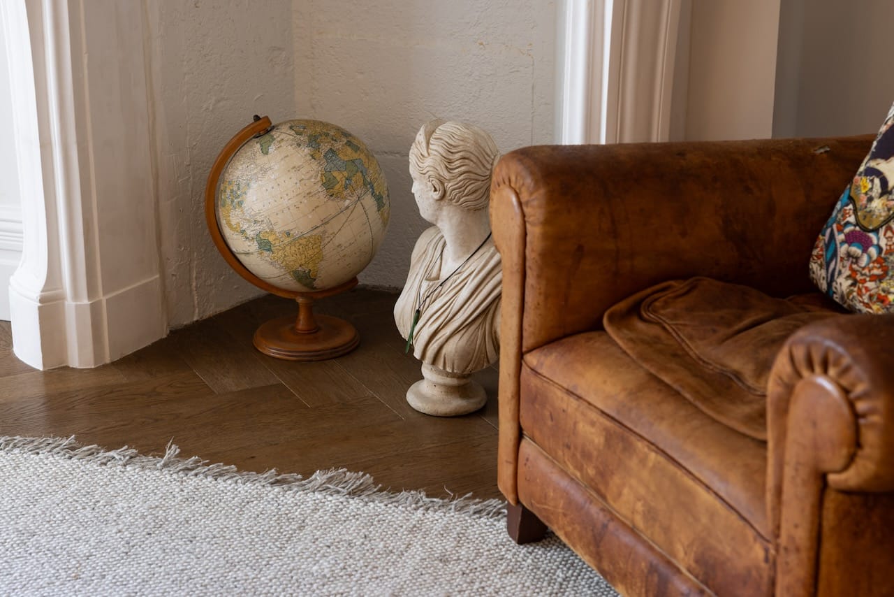 Whisky Sour Parquet Oak Wood Floor - 8 Herringbone Flooring with old style leather armchair