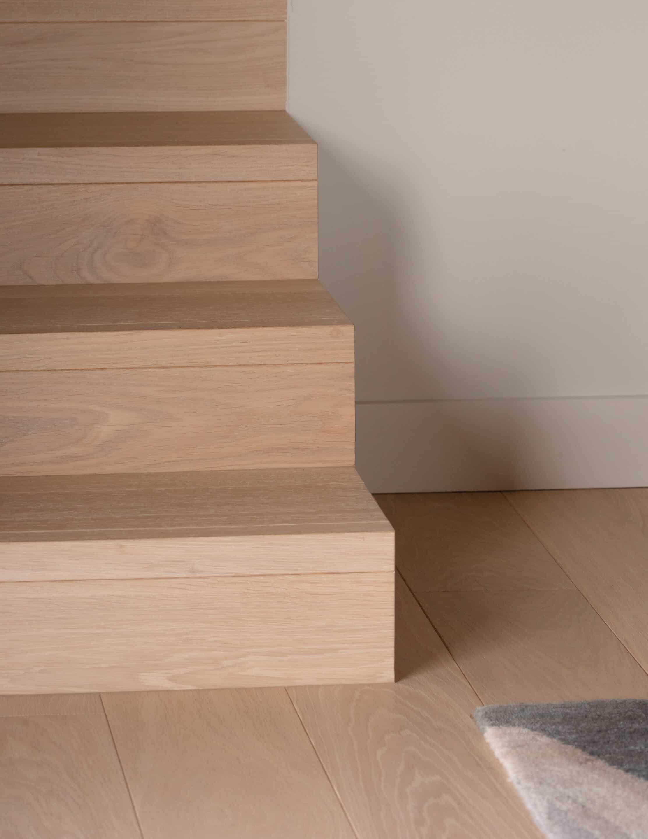Greenbelt House Stairs, showcasing Vienna Woods Sazerac Prime Grade Wood Flooring
