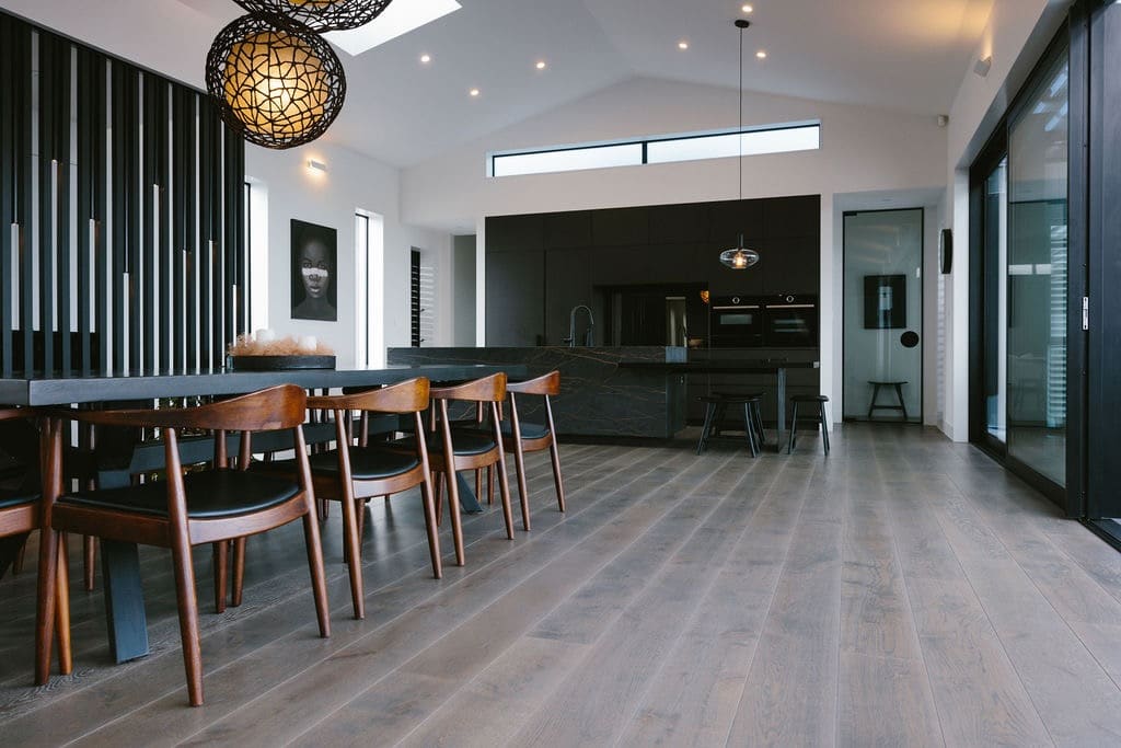 Distilled Collection Oak Pina - open living timber flooring Dark rich Oak flooring long lengths in open lounge dining and kitchen